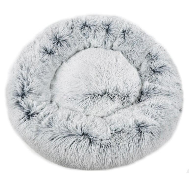 Round, fluffy pet bed on a white background