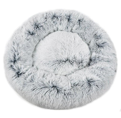 Round, fluffy pet bed on a white background
